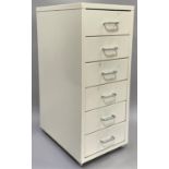 A white metal stationery filing drawer of six small drawers