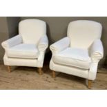 A pair of cream upholstered chairs on beech turned legs