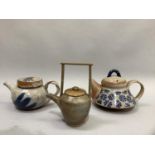 Studio pottery including a glazed teapot painted in blue and pale green on cream with twisted handle