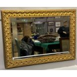A gilt framed wall mirror with bevelled glass, 93cm by 68cm