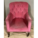 A late Victorian/Edwardian pink upholstered button back tub chair on turned legs and with brass