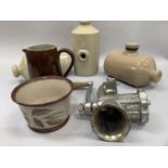 A set of three stoneware hot water bottles, brown glazed jug, mincer etc
