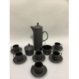 A Wedgwood black basalt coffee service of cylindrical form the coffee pot with domed cover, 6 coffee