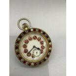 An early 20th century boudoir clock with spherical magnified glass case and gilt metal framed front,