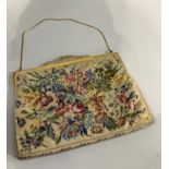 A petit point evening bag having a gilt metal frame and a bright cut and pierced clasp