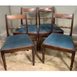 A set of four early 19th century mahogany dining chairs with ebony stringing to the bar back above a