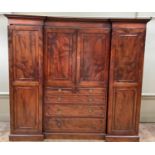 A mid 19th century figured mahogany wardrobe press, inverted breakfront, having a moulded and dentil