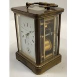 A carriage strike alarm clock by Matthew Norman in a brass case with five bevelled glass panels