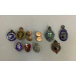 Three silver and enamelled cricketing fobs one with batsman at the crease together with various