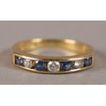 A SAPPHIRE AND DIAMOND SET HALF HOOP RING IN 18CT GOLD, the brilliant cut diamonds and circular