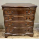 A reproduction mahogany serpentine chest of drawers having a pull slide above four graduated drawers