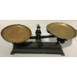 A set of iron weighing scales with brass pans