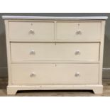 An early 20th century cream painted pine chest of two short over two long drawers, later ceramic