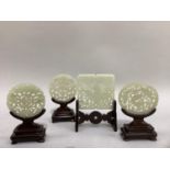 Four pierced jade-style plaques of square, oval and circular form variously pierced with a design of