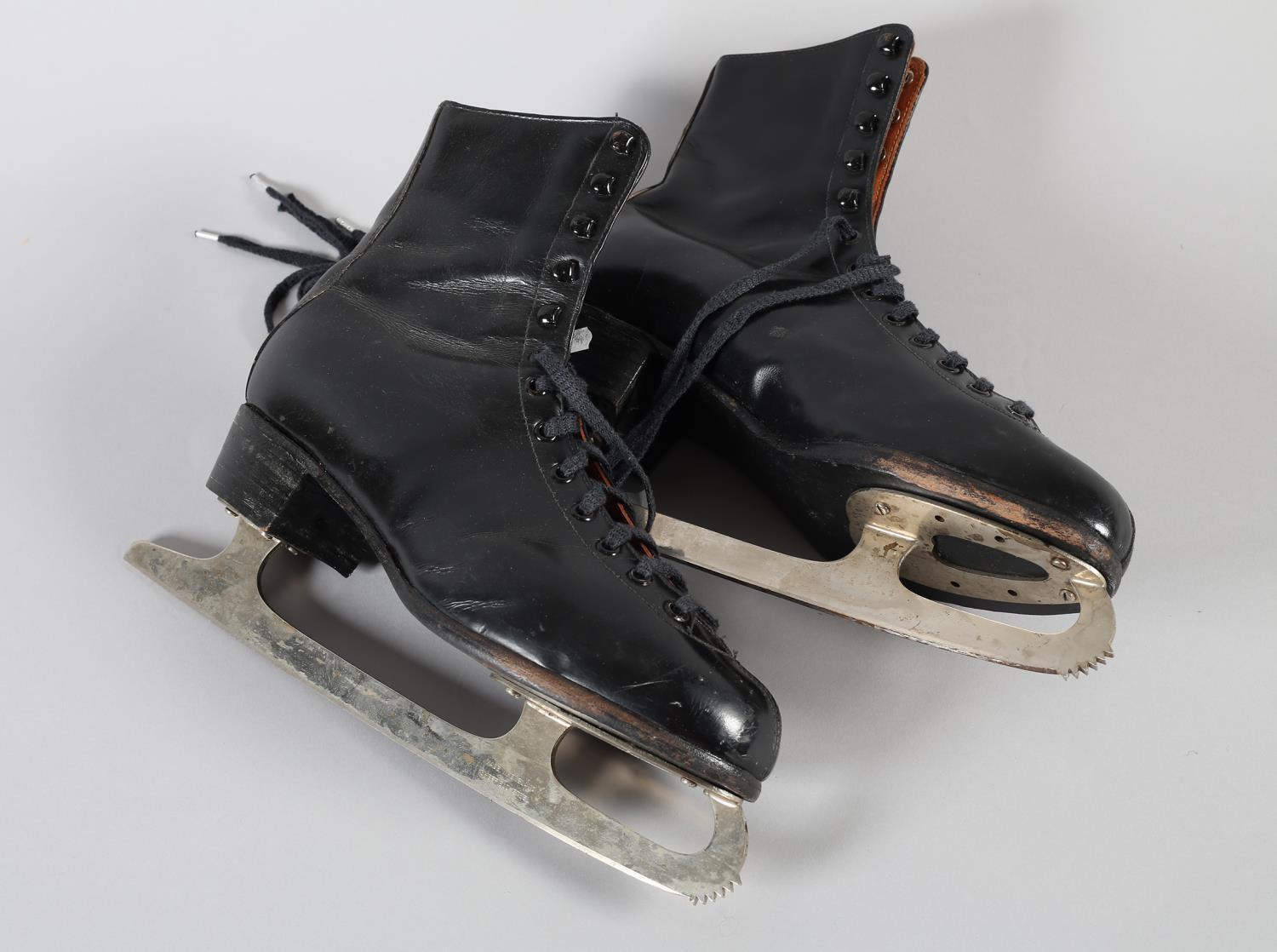 A pair of black leather ice skates, front lacing, marked size 9.5, inked with the name D. Churchill