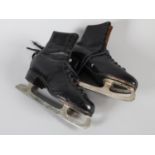 A pair of black leather ice skates, front lacing, marked size 9.5, inked with the name D. Churchill