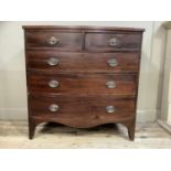 An early 19th century mahogany bow front chest of two short and three long graduated drawers with