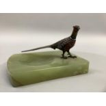 A cold painted bronze pheasant mounted onyx ash tray 14cm wide x 8.5cm high.