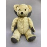 A Deans teddy bear with blonde plush, plastic eyes, stitched nose, paw pads and with Deans Child's