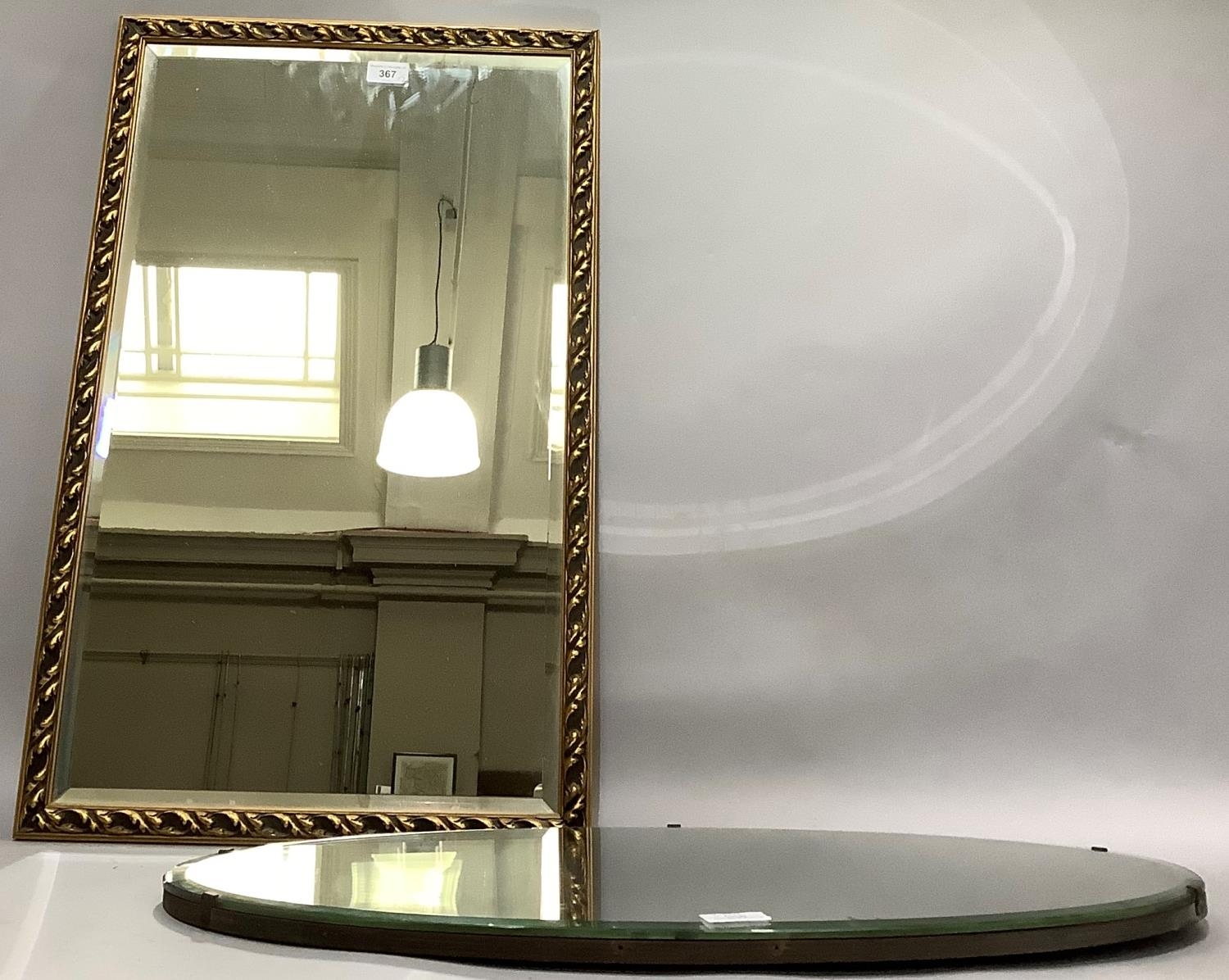 A gilt framed rectangular wall mirror and an oval bevelled wall mirror