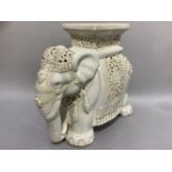 A white glazed elephant with incised decoration, 52cm wide by 44cm high