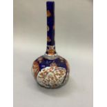 An Imari bottle vase having a lobed compressed circular body with extended neck, painted in