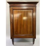 An Edwardian mahogany hanging cupboard inlaid with boxwood stringing and satinwood banding, having a