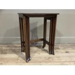 An early 20th century nest of three mahogany rectangular tables on slender square standards