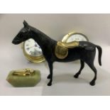 A bronze effect horse, a brass cased clock and matching barometer and an onyx table lighter