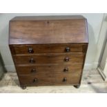 A mahogany bureau having a fall front over five graduated drawers with turned handles and feet