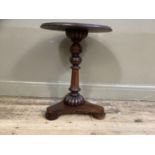 A mahogany and rosewood circular pedestal table,19th century and later on a tripartite base and