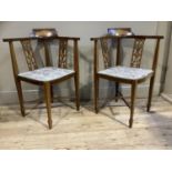A pair of Edwardian mahogany and satinwood inlaid corner chairs with pierced splats