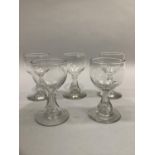 A set of five 19th century port glasses with faceted hollow stem on circular foot with smooth