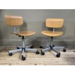 A pair of beech laminate office chairs on five spoke base with castors