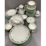 A Royal Worcester china tea and dinner service with fluted and floral rims