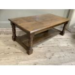 An oak rectangular coffee table on turned and square framing joined by a pot board