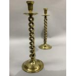 A pair of 19th century brass ecclesiastical candlesticks with interwoven spiral stems and circular