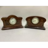 An early 20th century mahogany boxwood and ebony inlaid mantel clock having a circular enamel dial