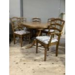 A pine extending dining table and six pine ladder back dining chairs