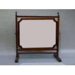 A mahogany toilet mirror having a rectangular plate with cut away corners and on square tapered