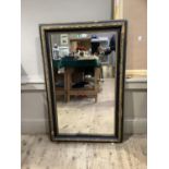 A black and gilt framed wall mirror, rectangular, 112cm x 72cm, some moulding loss