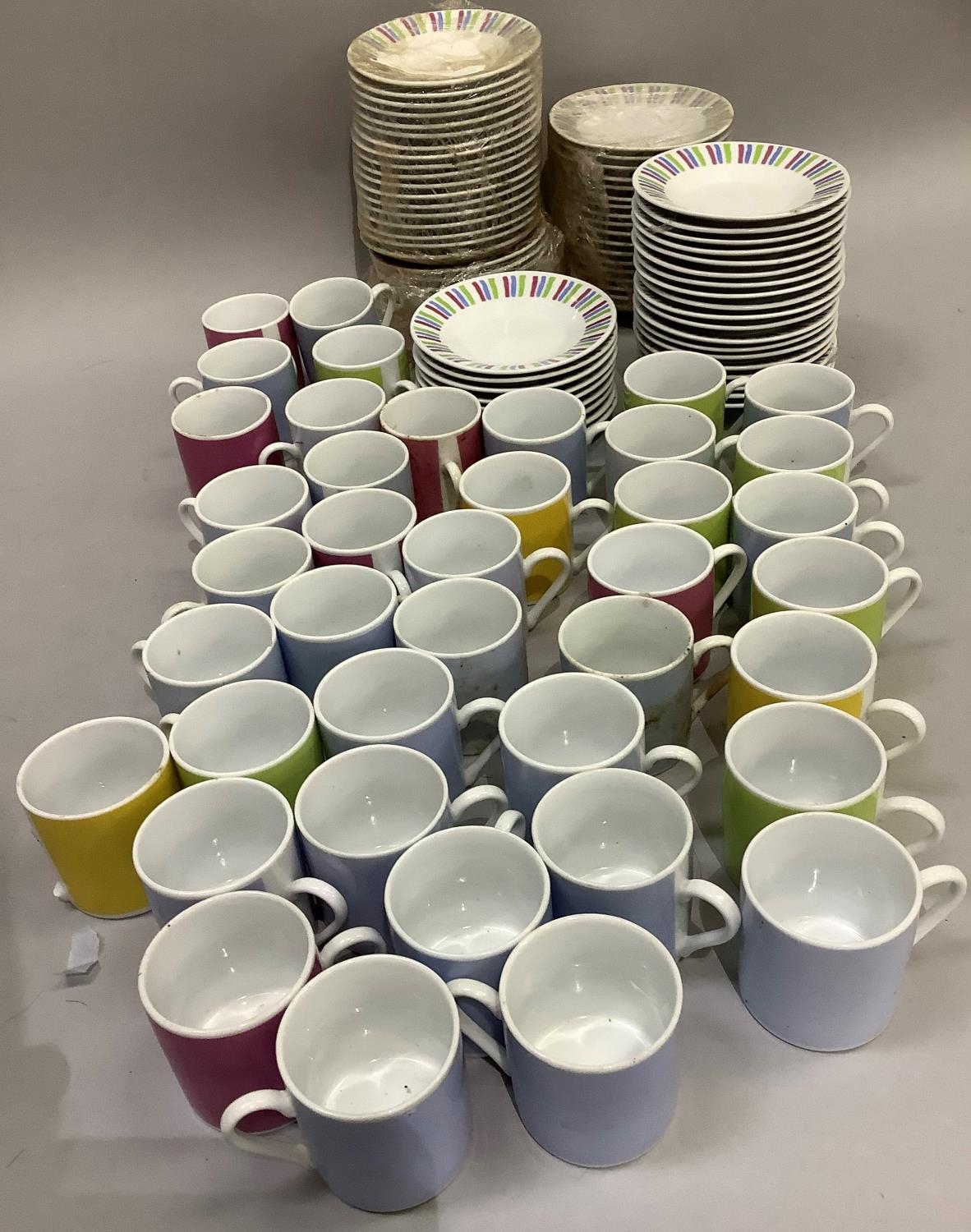 A large quantity of harlequin coffee cans and saucers with striped borders