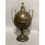 A late Victorian copper and brass two handled tea urn with finial and on circular spreading foot