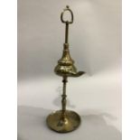 A late 19th century Italian brass Lucerne oil lamp circa 1880, having a loop handle, turned column