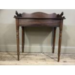 A 19th century mahogany washstand with three quarter gallery on slender turned legs