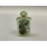 A Chinese glass snuff bottle internally painted with a mountain and river landscape with sampans,