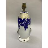 A Rosenthal china lamp base printed in underglaze blue and gilt with scrolling leafage, on a white