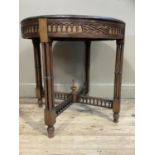 An Edwardian mahogany circular window table having a blind fret work frieze, on four cluster ring