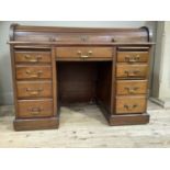 An early 20th century mahogany tambour fronted desk with pedestal drawers each with a pull out slide