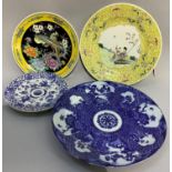 Four Chinese plates in blue and white and in famille rose and yellow, variously decorated